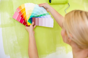 Woman with scale of paint swatches choosing color