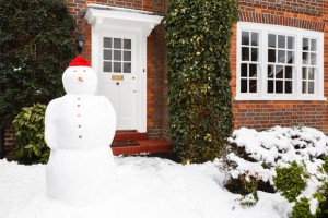 Snowman outside house